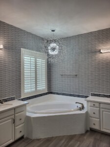 Bathroom with tub and designer wallpaper